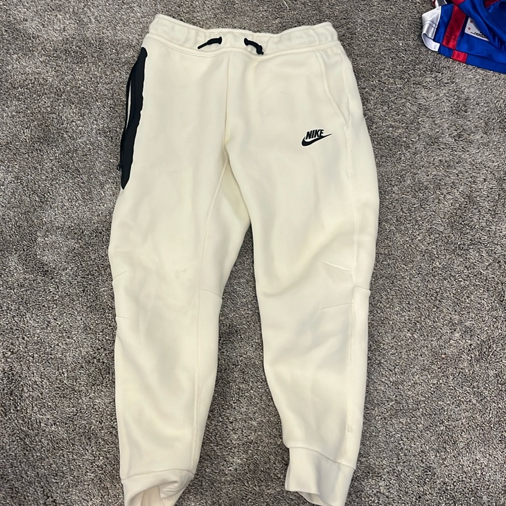 Light tan kids Nike tech pants